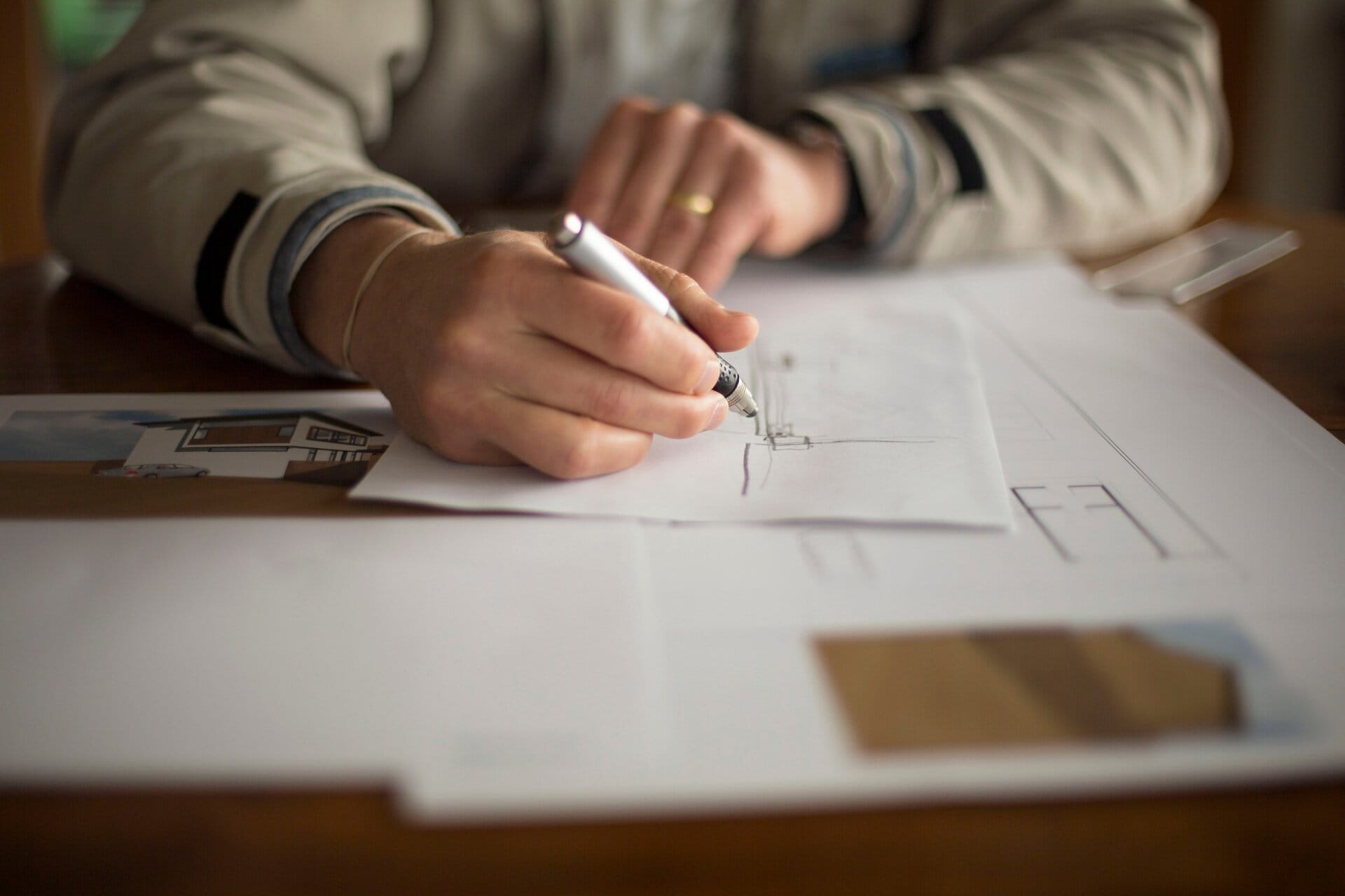 Mid-section of man doing technical drawing